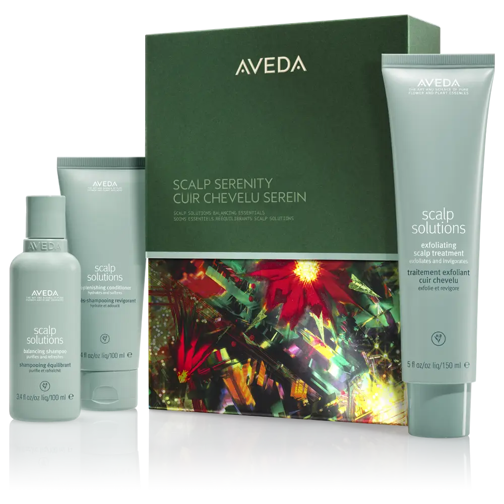Three Aveda Scalp Solutions hair care products and a green box with red floral design are displayed on a white background, perfect for creating seasonal hairstyles or inspiring festive hair ideas. - Trios Aveda Salon | Fort Collins, CO
